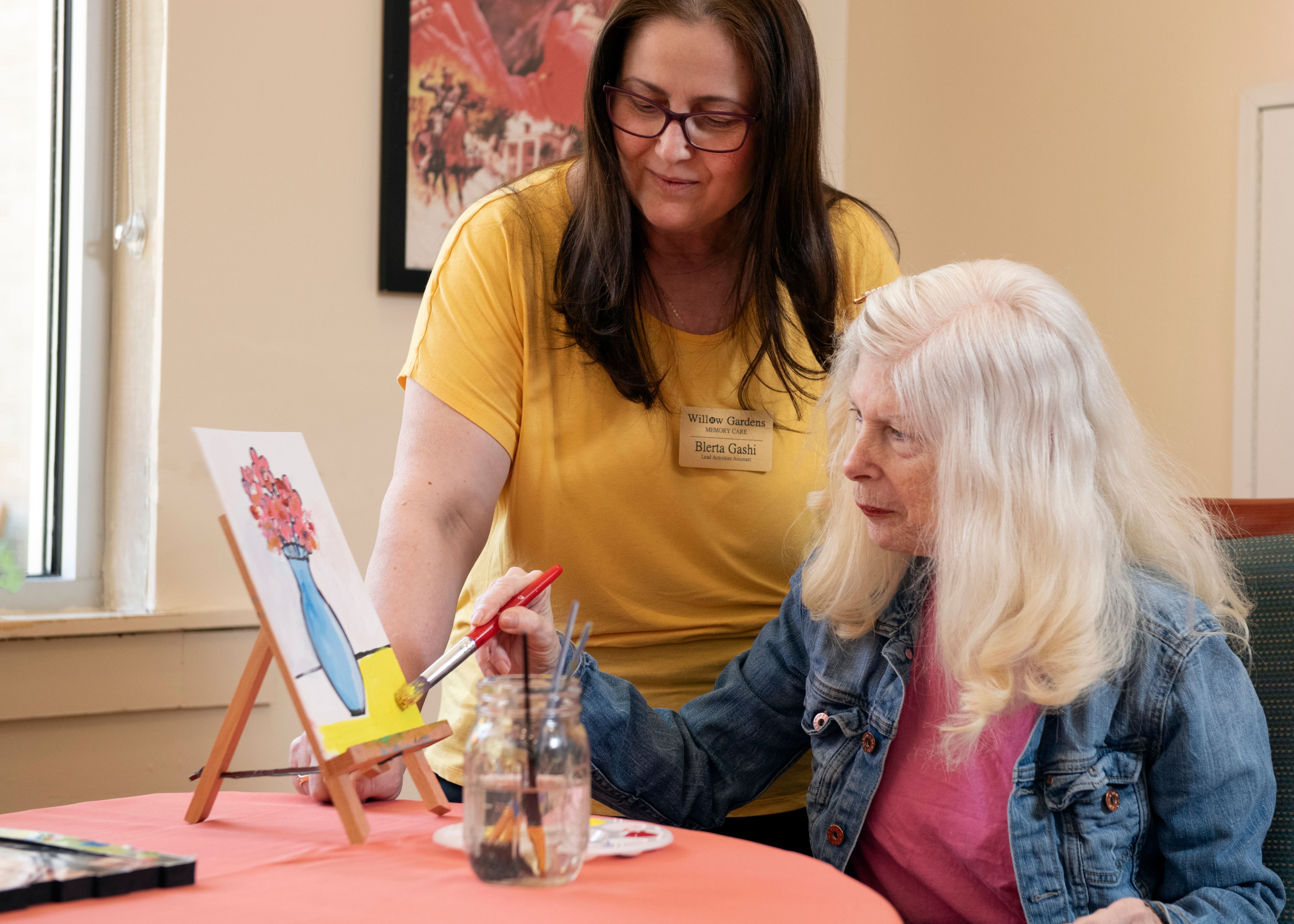 Willow Gardens staff painting with resident 