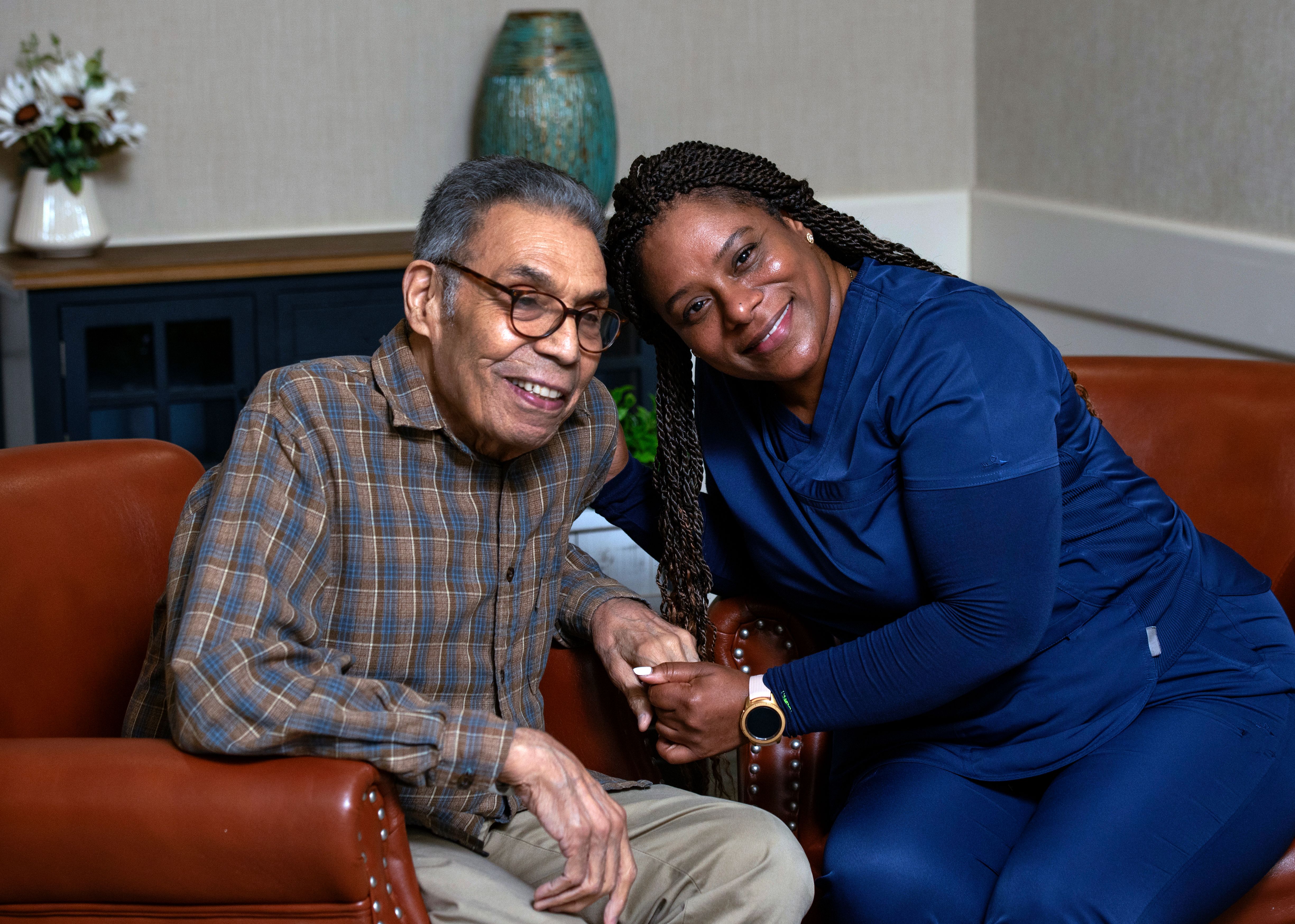 Memory care caregiver on couch with resident